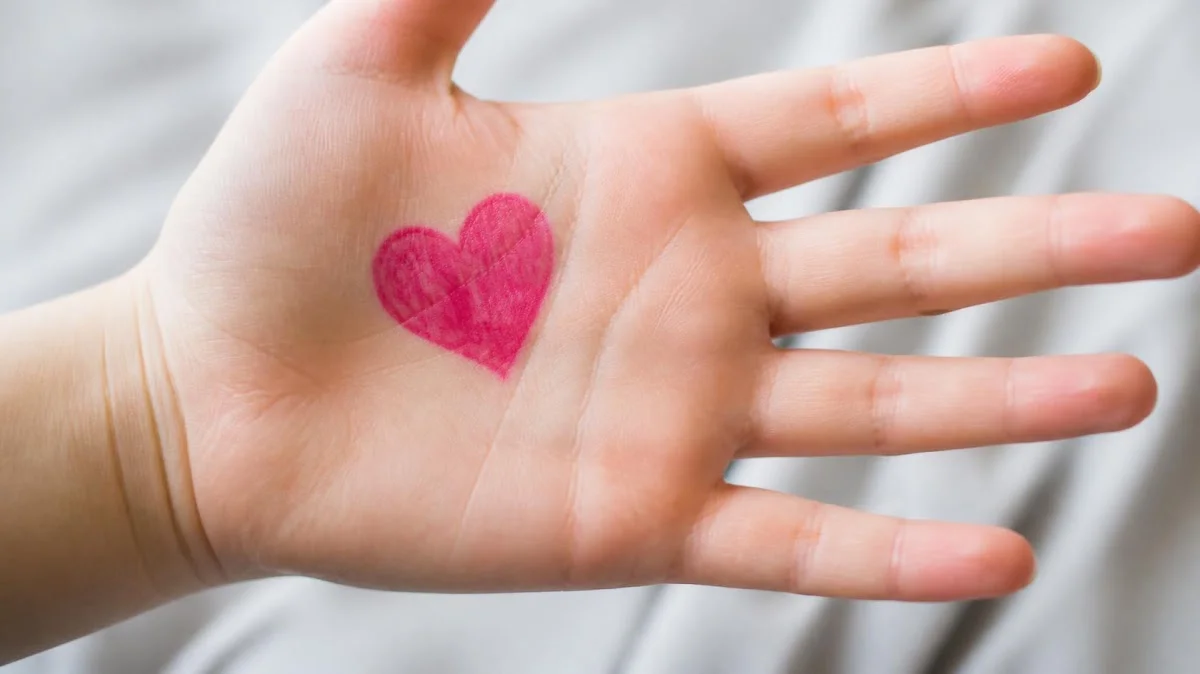 Heart drawn on childs palm in washable marker