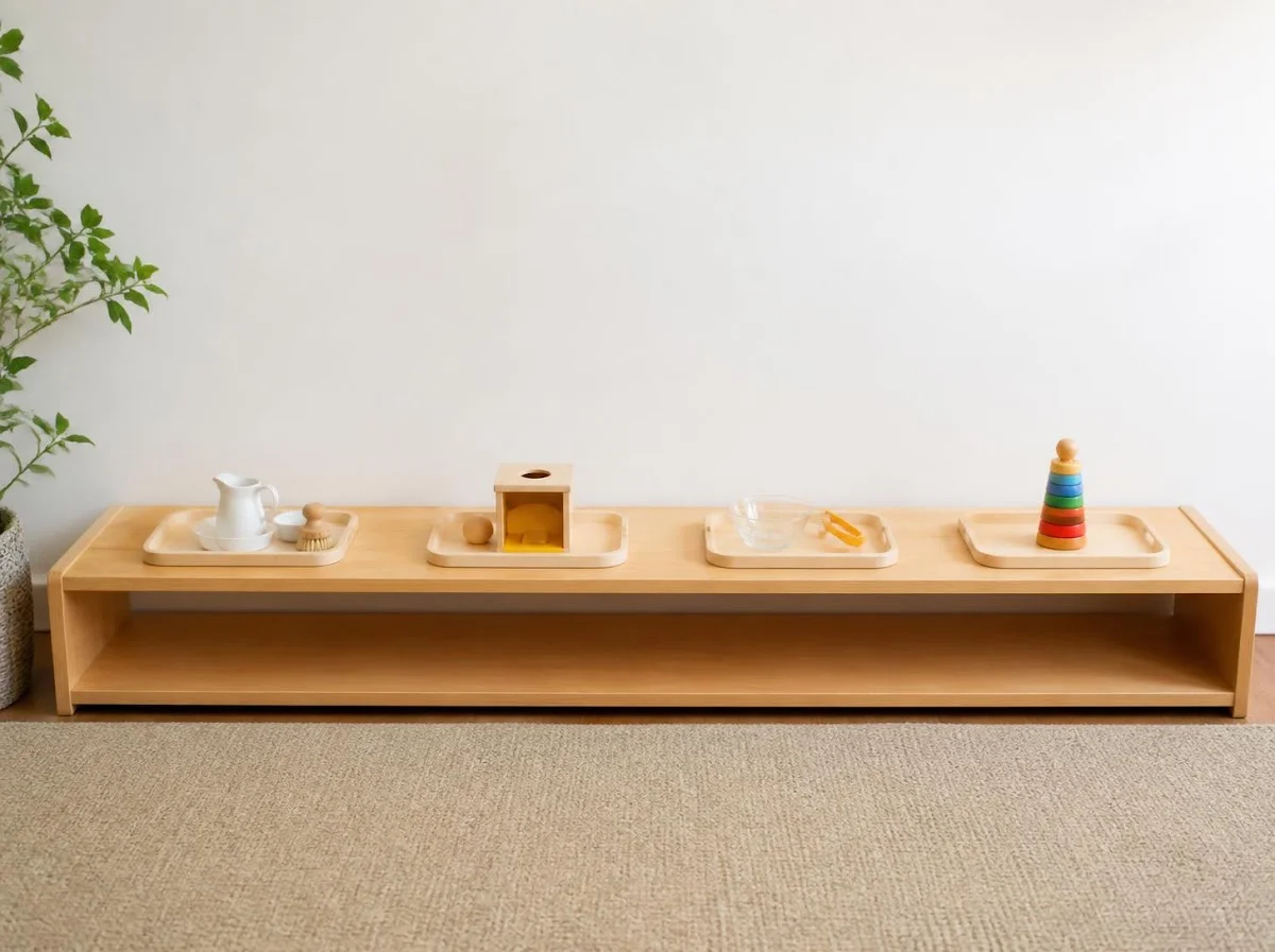 Low wooden Montessori shelf with four activity trays