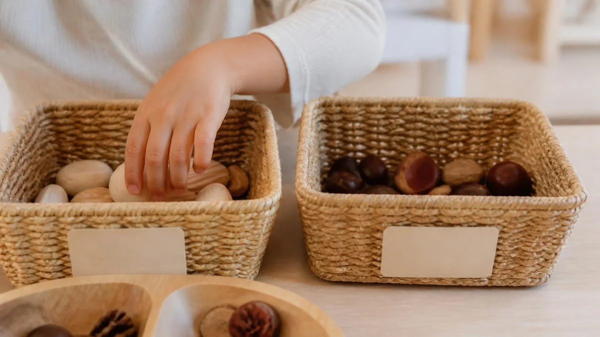 Child hands sorting items into labeled baskets